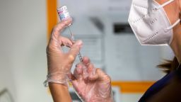 A healthcare worker prepares a dose of the Moderna Covid-19 vaccine at the Brooklyn Children's Museum vaccination site in Brooklyn, New York, in June.