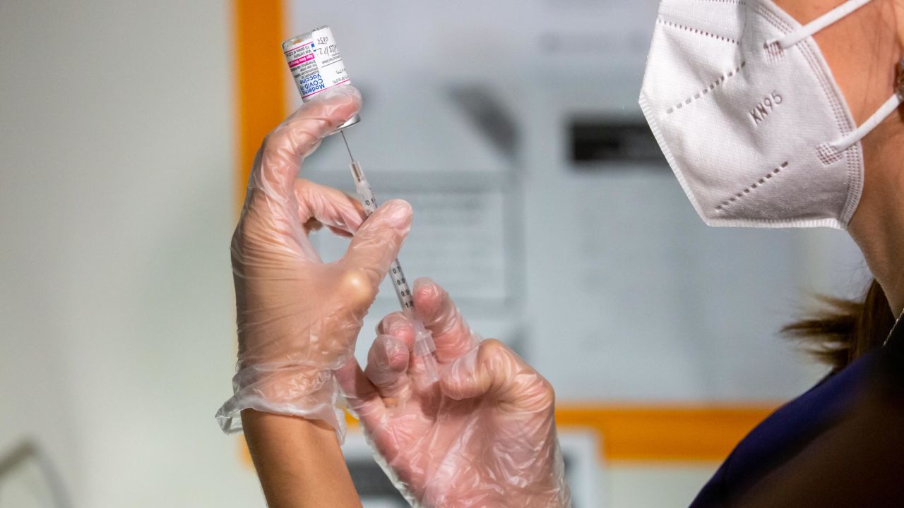 A health care worker prepares a dose of the Moderna Covid-19 vaccine at the Brooklyn Children's Museum vaccination site in Brooklyn, New York, in June.