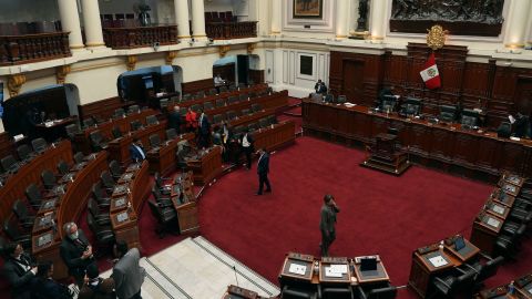 Lawmakers stand inside Congress on the day of their planned impeachment vote on President Pedro Castillo in Lima, Peru, Wednesday, Dec. 7, 2022.