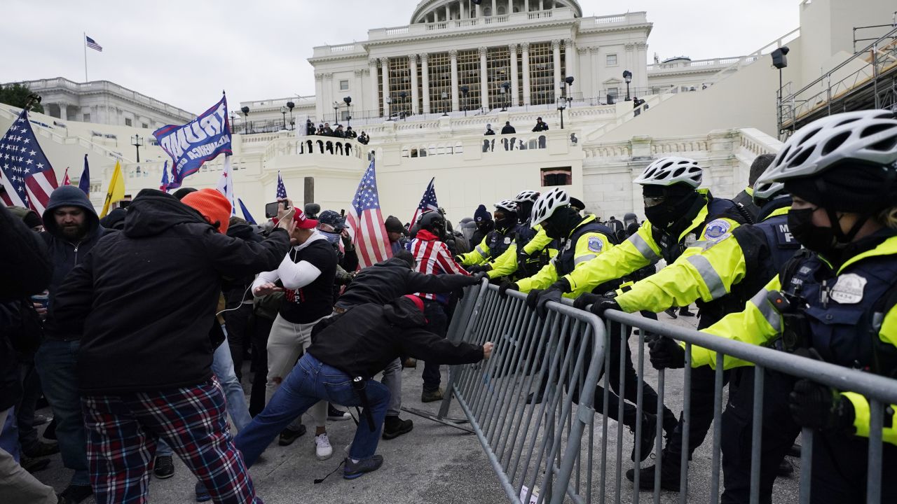 FILE - Insurrectionists loyal to President Donald Trump try to break through a police barrier, Wednesday, Jan. 6, 2021, at the Capitol in Washington. Top House and Senate leaders will present law enforcement officers who defended the U.S. Capitol on Jan. 6, 2021, with Congressional Gold Medals on Wednesday, Dec. 7, 2022, awarding them Congress's highest honor nearly two years after they fought with former President Donald Trump's supporters in a brutal and bloody attack. (AP Photo/Julio Cortez, File)