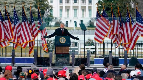 With the White House in the background, then-President Donald Trump speaks at a 