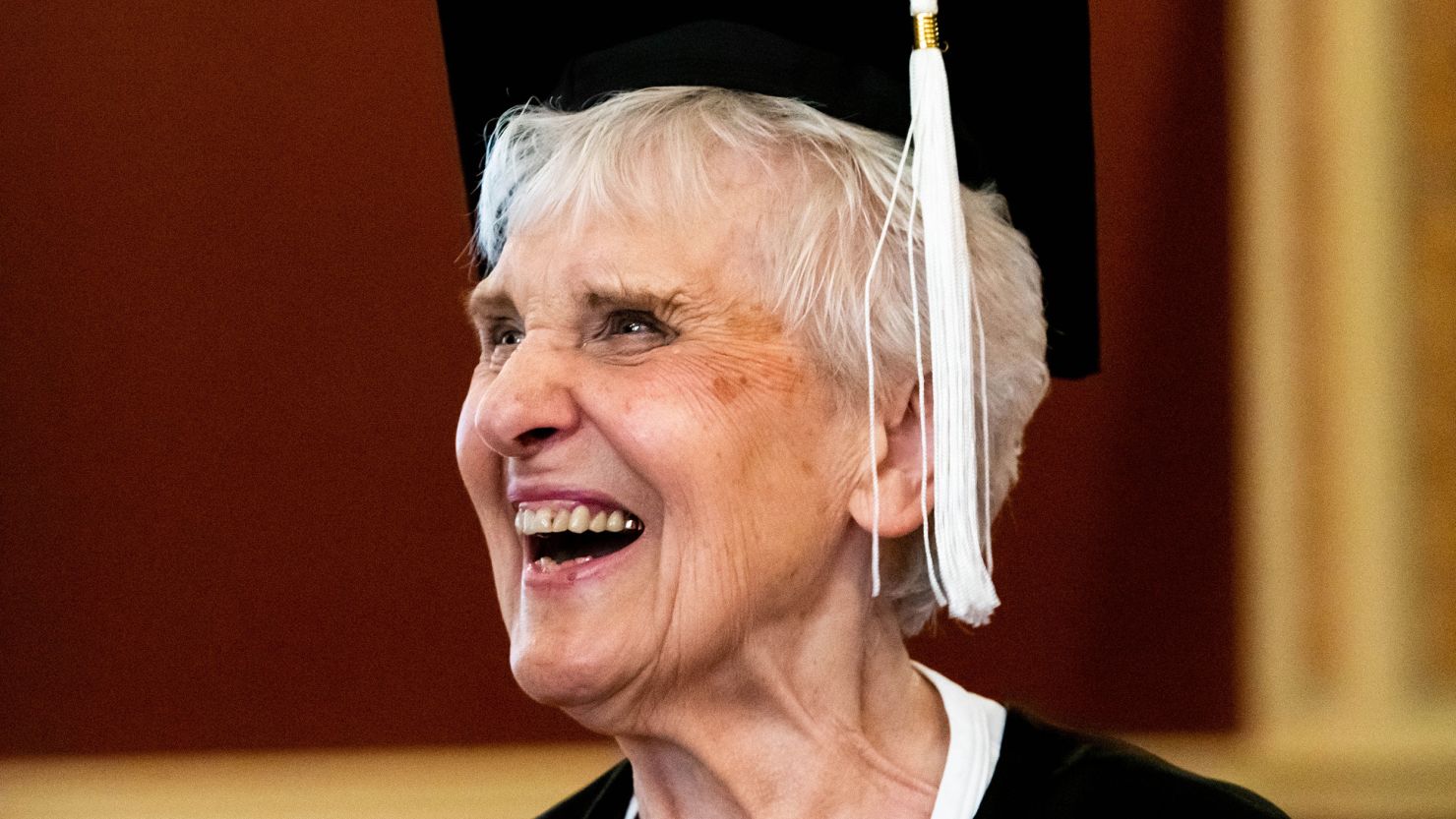 Joyce DeFauw tries on a graduation cap during a visit to the NIU campus in August.