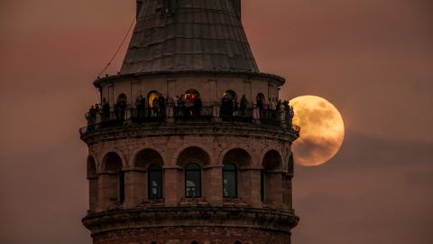 The last full moon of the year rises behind Galata tower in Istanbul on Wednesday. (AP Photo/Emrah Gurel)