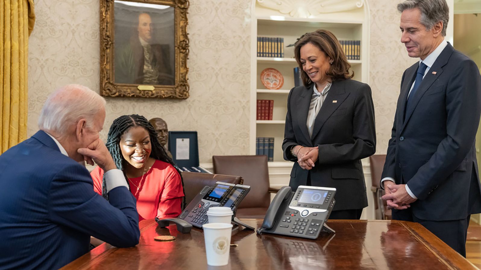 Griner's wife, Cherelle, sits with President Joe Biden as they talk with Griner on the phone after her release in December 2022. This photo was tweeted on the president's account, saying about Griner: "She is safe. She is on a plane. She is on her way home." On the right are Vice President Kamala Harris and Secretary of State Antony Blinken.