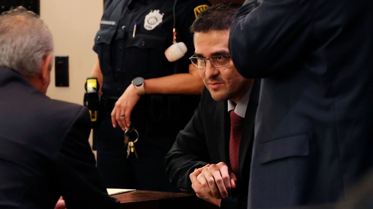 Capital murder defendant and former U.S. Border Patrol Juan David Ortiz talks with one of his attorneys, Joel Perez, before the start of the first day of the trial before Webb County State District Court Judge Oscar J. Hale, Monday, Nov. 28, 2022. Ortiz is charged in the 2018 deaths of four women near Laredo. The trial was moved to San Antonio because of pretrial media coverage in Laredo. (Jerry Lara/The San Antonio Express-News via AP)