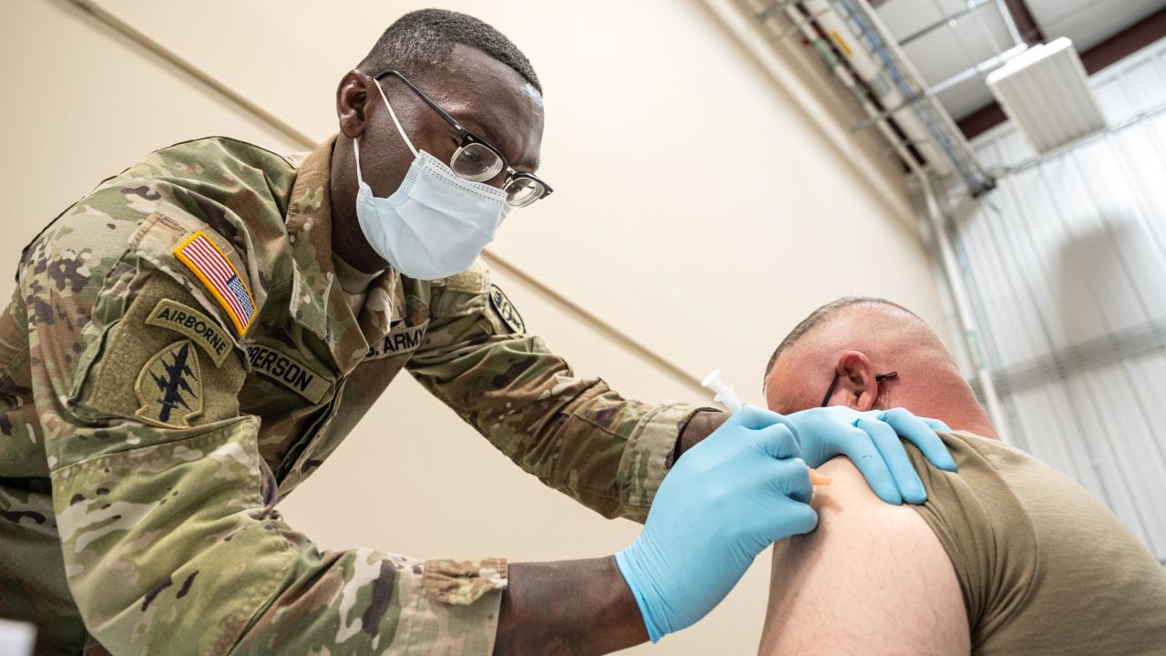 Preventative Medicine Services NCOIC Sergeant First Class Demetrius Roberson administers a Covid-19 vaccine to a soldier in September 2021 in Fort Knox, Kentucky. 
