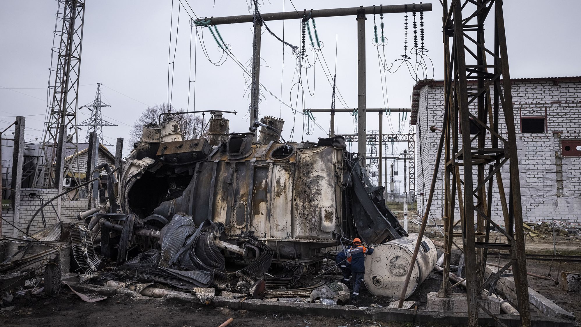 Workers dismantle an autotransformer on November 10 in central Ukraine. It was completely destroyed when the Ukrenergo high voltage power substation was hit by a missile strike on October 17.