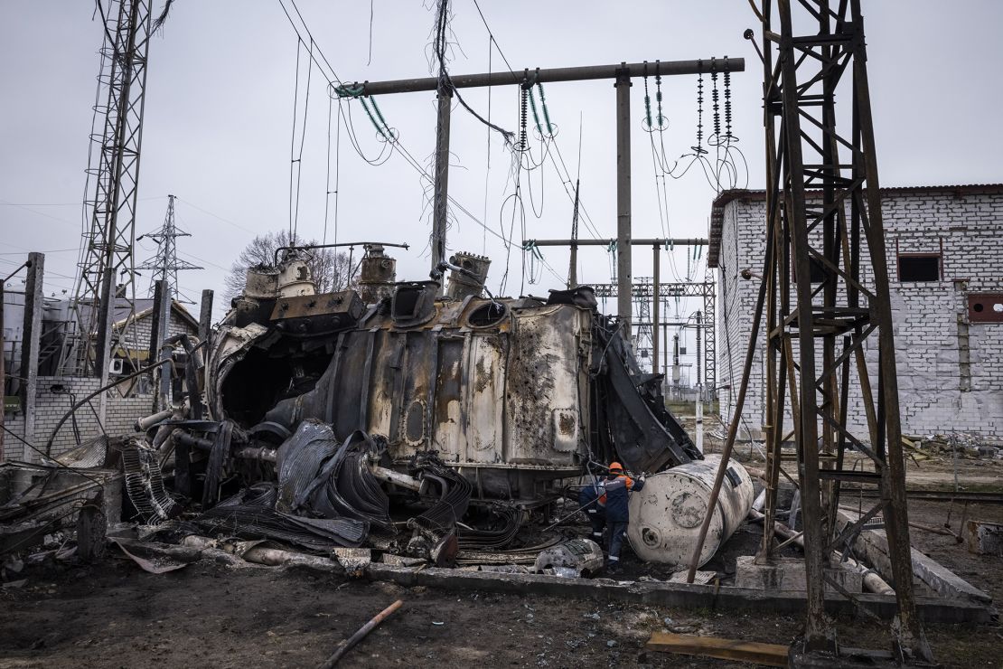 Workers dismantle an autotransformer on November 10 in central Ukraine. It was completely destroyed when the Ukrenergo high voltage power substation was hit by a missile strike on October 17.
