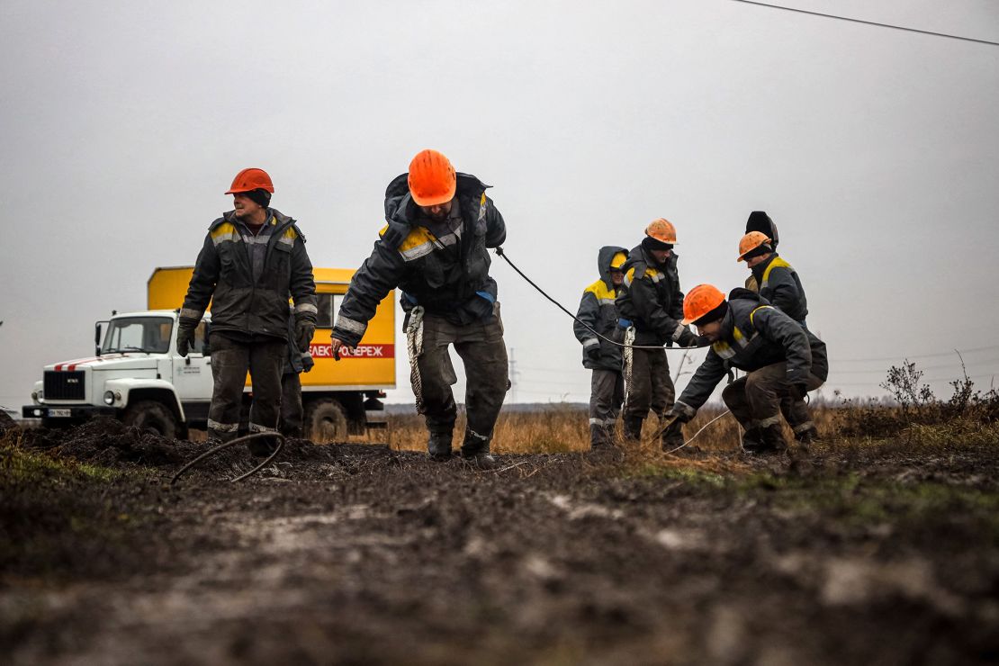Workers repair high-voltage power lines cut by recent missile strikes near Odesa on December 7, 2022, amid the Russian invasion of Ukraine.