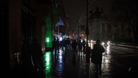 Amid the blackouts, lighting on the streets is minimal, with the majority coming from public transport and car headlights in the western city of Lviv on November 16, 2022.