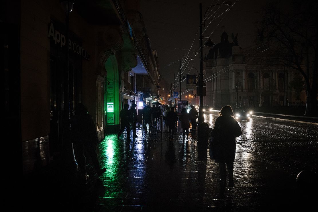 Amid the blackouts, lighting on the streets is minimal, with the majority coming from public transport and car headlights in the western city of Lviv on November 16, 2022.