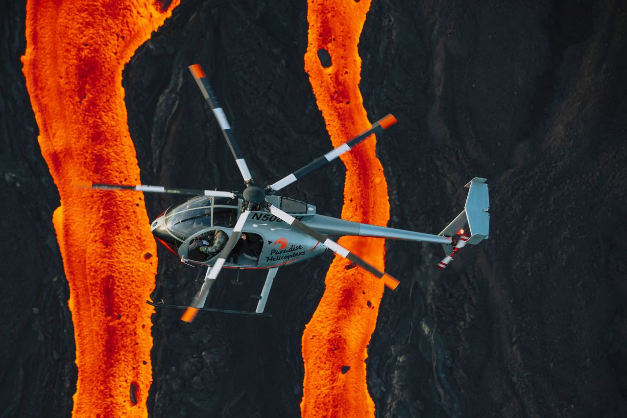 A helicopter flies past lava fissures on December 7.