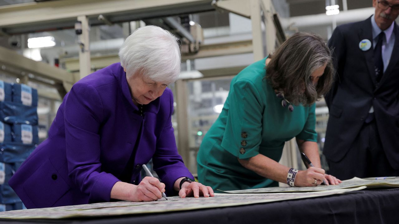 U.S. Treasury Secretary Janet Yellen and U.S. Treasury Chief Lynn Malerba sign banknotes.   
