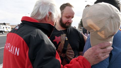 James Slaugh (center) prays with others at a memorial outside Club Q on November 23, 2022. 