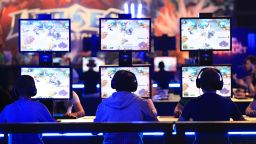 Gamers wear headsets as they sit at a bank of monitors and play Activision Blizzard Inc.'s Heroes of the Storm computer game at the Gamescom video games trade fair in Cologne, Germany, on Wednesday, Aug. 5, 2015. 