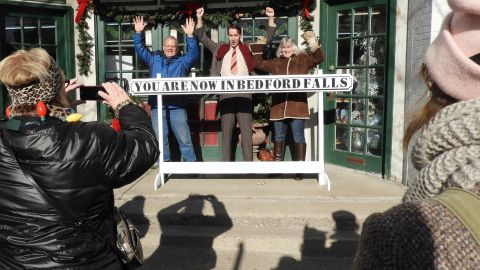 Joined by movie buffs, actor Brian Rohan, dressed as George Bailey, poses for photos during the It's a Wonderful Life Festival in Seneca Falls, New York, in 2017.