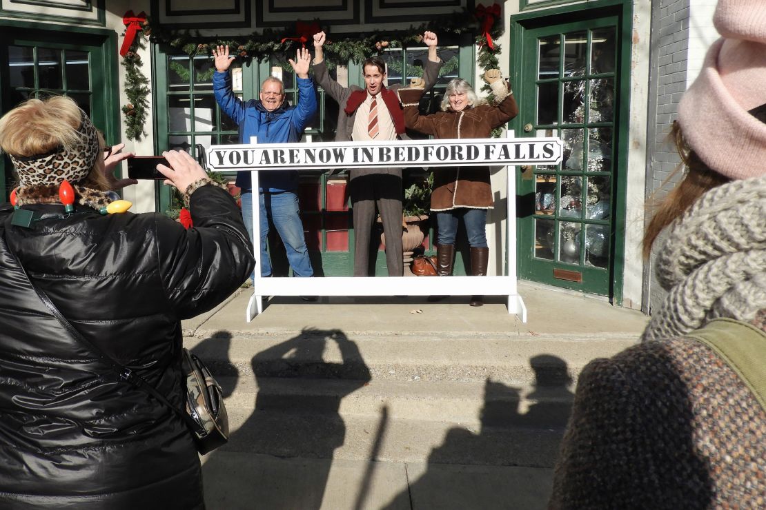 Joined by movie buffs, actor Brian Rohan, dressed as George Bailey, poses for photos during the It's a Wonderful Life Festival in Seneca Falls, New York, in 2017.