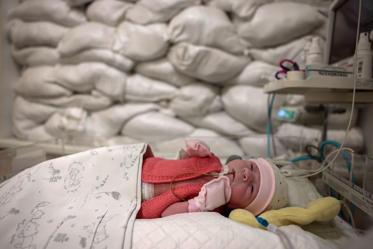 A newborn rests in a hospital's intensive care unit where the window is protected by sandbags in Kyiv, Ukraine, on Tuesday, December 6.
