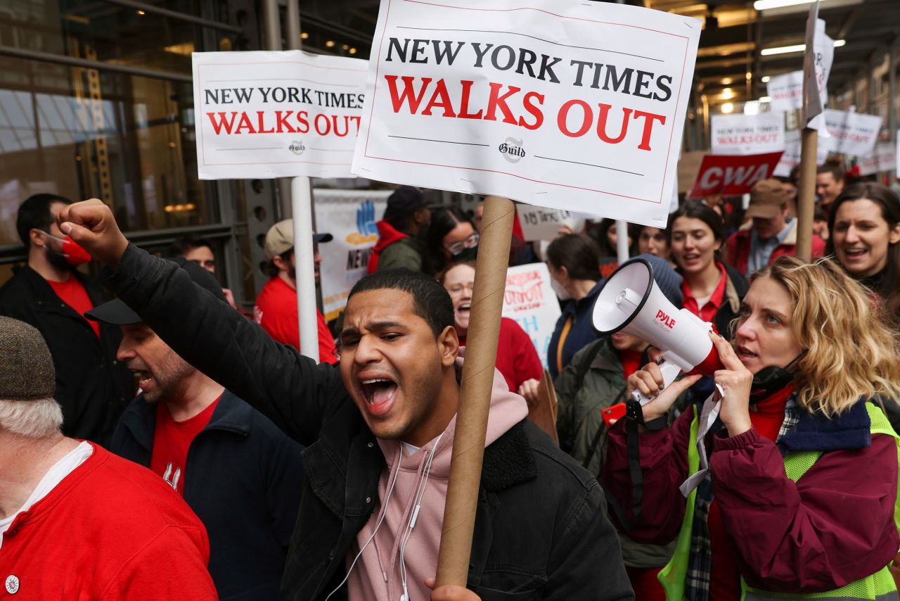 Hundreds of New York Times journalists and other staff members picket outside the Times' office after walking off the job on Thursday, December 8. A <a href=