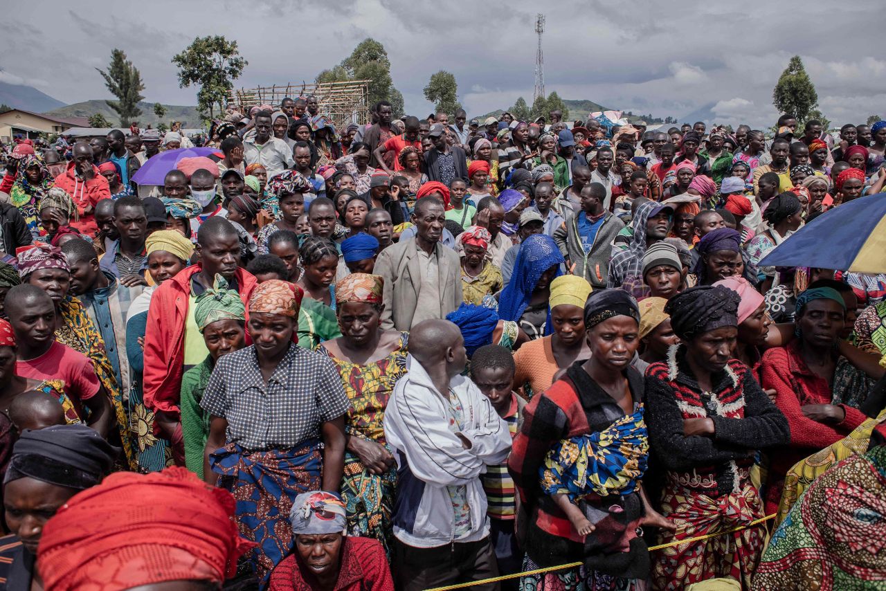 Displaced people wait for UNICEF to distribute food and other items at a camp on the outskirts of Goma, Democratic Republic of Congo, on Monday, December 5. Thousands of people fled clashes between the army and the M23 rebel group.