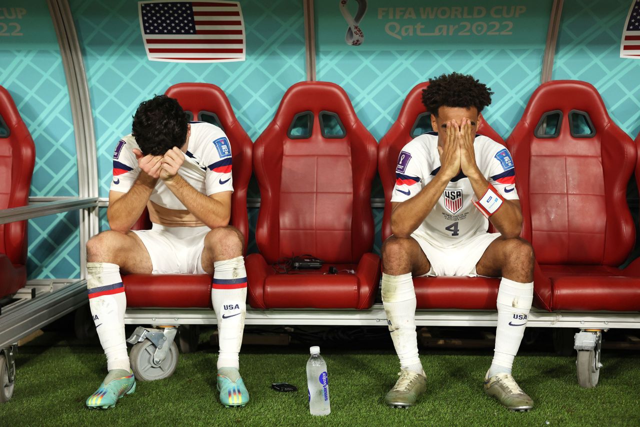 US soccer players Giovanni Reyna, left, and Tyler Adams sit with their heads in their hands after being <a href=