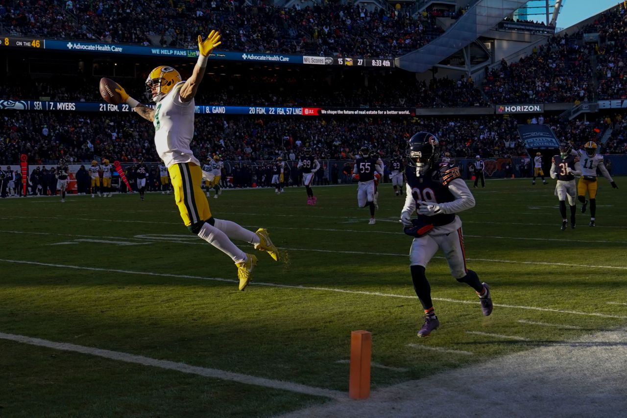 Green Bay wide receiver Christian Watson leaps over the goal line for a touchdown during an NFL game in Chicago on Sunday, December 4. Green Bay won 28-19. <a href=