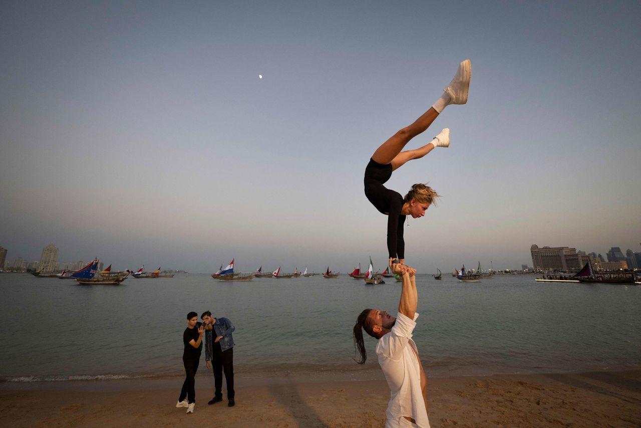 Gymnasts perform on a beach in Doha, Qatar, on Saturday, December 3.