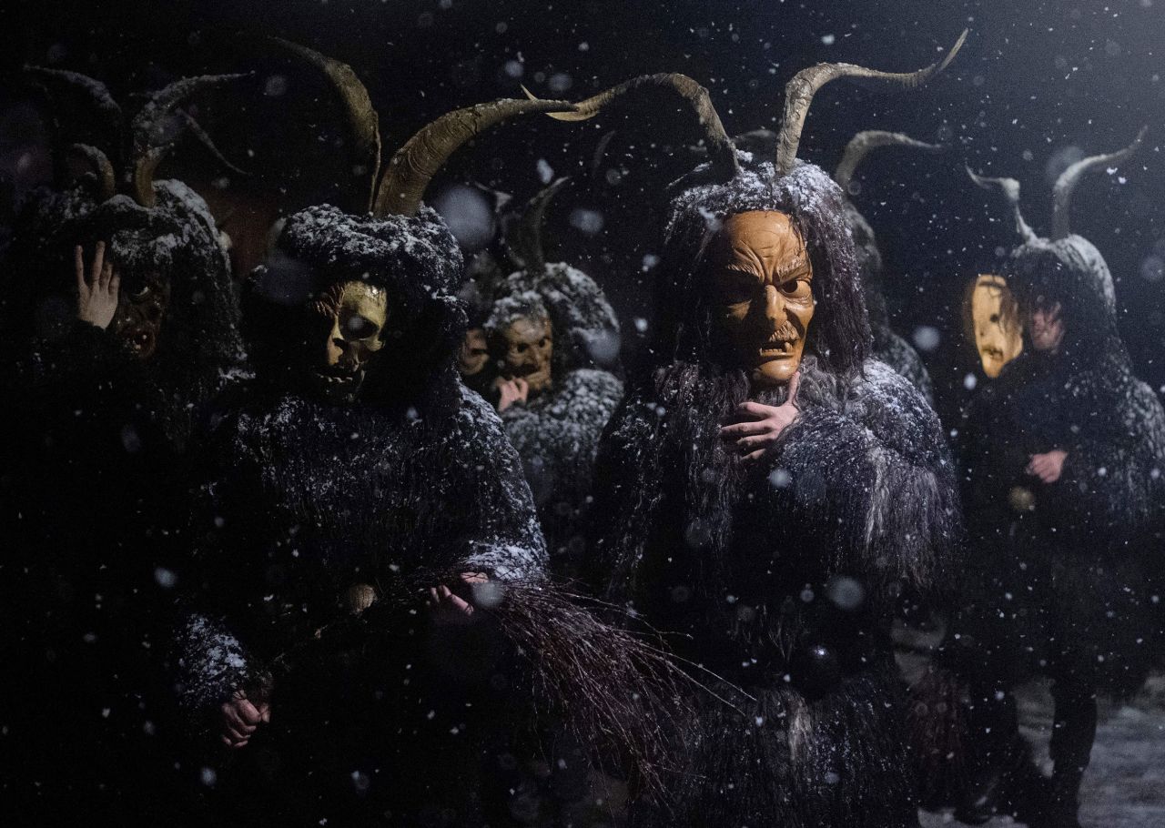 Revelers wear devil masks and black sheepskin representing <a href="https://www.cnn.com/2016/12/21/health/strange-christmas-traditions" target="_blank">Krampus</a> during a traditional holiday performance in Bad Mitterndorf, Austria, on Monday, December 5.