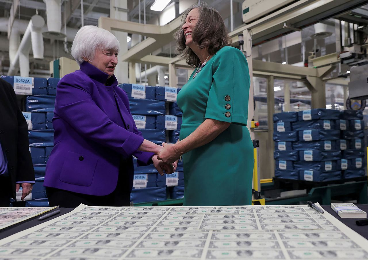 US Treasury Secretary Janet Yellen, left, holds the hands of US Treasurer Lynn Malerba at the unveiling of <a href="https://www.cnn.com/2022/12/08/economy/us-currency-first-time-two-women-signatures/index.html" target="_blank">the first US banknotes printed with two women's signatures</a> Thursday, December 8, in Fort Worth, Texas.