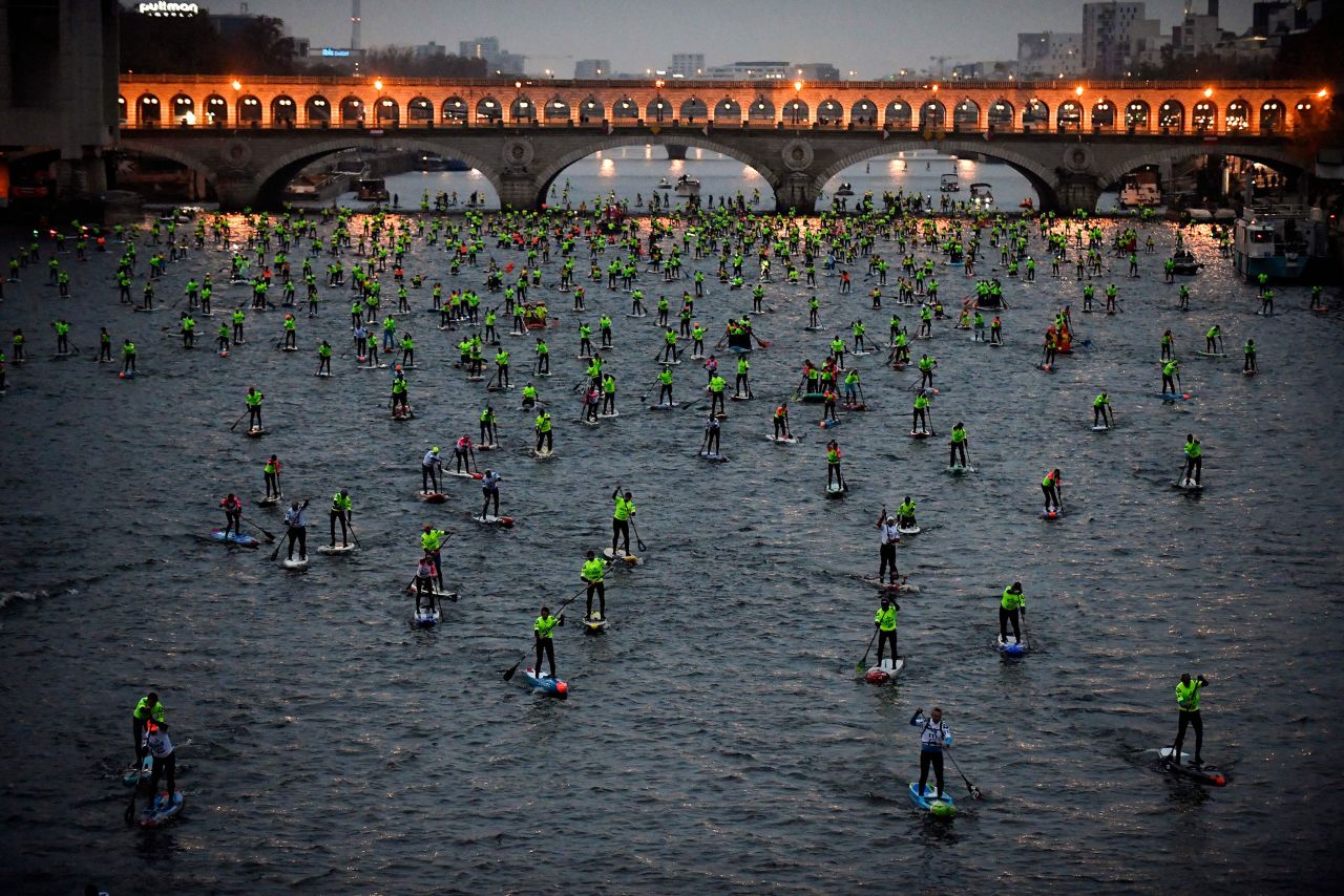 Paddleboarders compete in a race on the Seine River in Paris on Sunday, December 4.