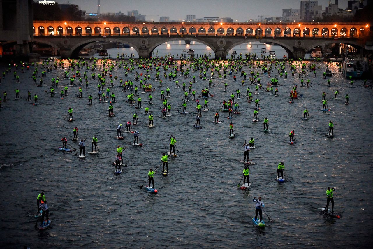 Paddleboarders compete in a race on the Seine River in Paris on Sunday, December 4.