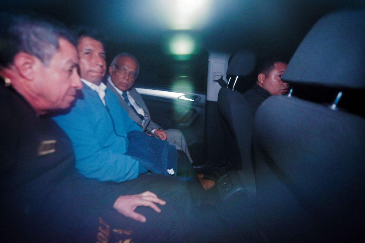 Ousted Peruvian President Pedro Castillo sits in a car after leaving a police station in Lima, Peru, on Wednesday, December 7. <a href=