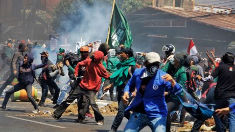 Protesters throw stones at riot police September 24, 2019, as demonstrations unfold in Jakarta and other cities against proposed changes to Indonesia's penal code laws.  The changes were later watered down, but remain controversial.