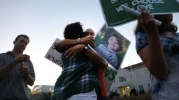NEWTOWN, CT - OCTOBER 04:  Mark Barden gets a hug while holding up a picture of his son Daniel who was killed in the Sandy Hook masracre during a vigil honoring the 59 people killed the shooting in Las Vegas and calling for action against guns on October 4, 2017 in Newtown, Connecticut. The vigil, organized by the  Newtown Action Alliance, was held outside the National Shooting Sport Foundation and looked to draw attention to gun violence in America. Twenty school children were killed at the Sandy Hook Elementary School shooting on December 14, 2012.  (Photo by Spencer Platt/Getty Images)