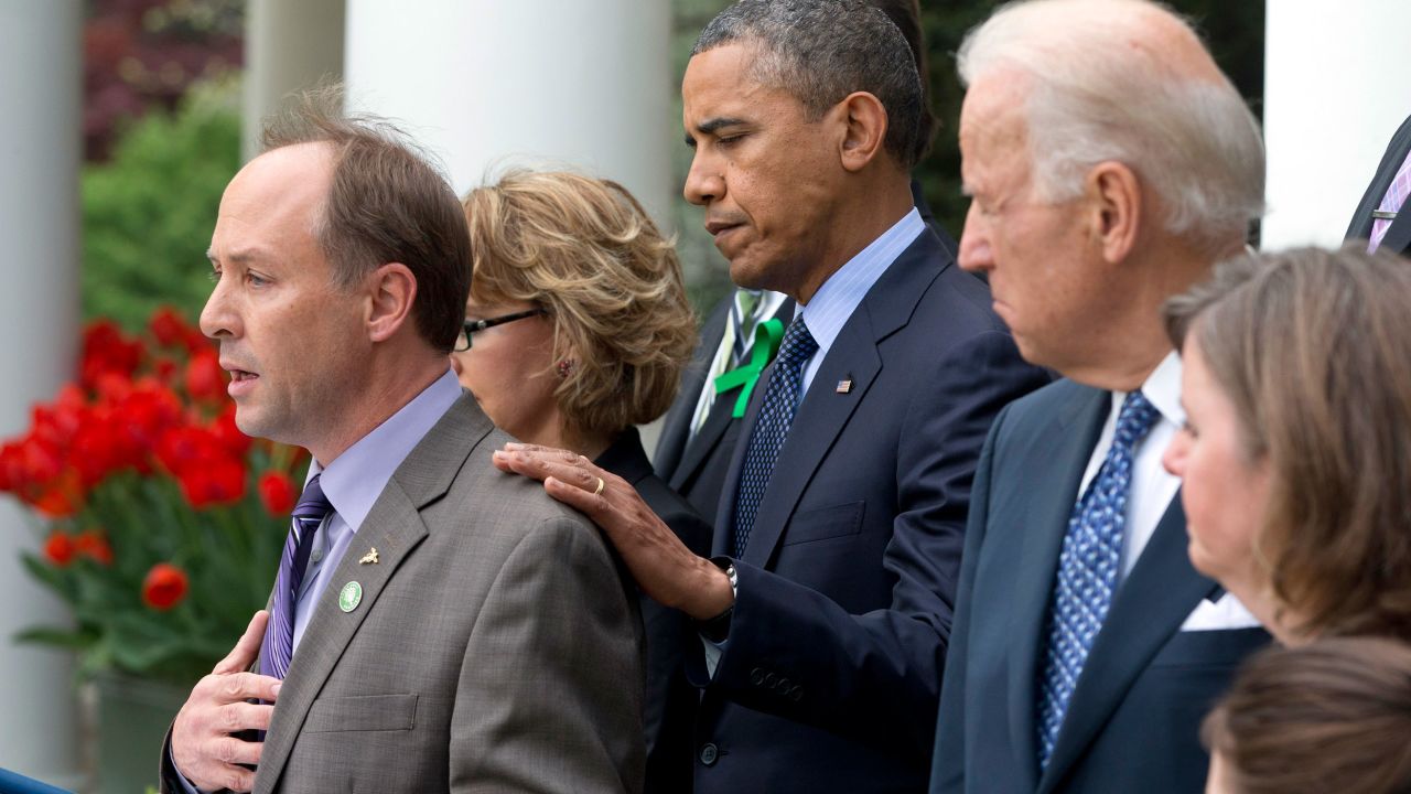 President Barack Obama places his hand on Mark Barden, left, during a 2013 news conference after the defeat of a bill to expand background checks.
