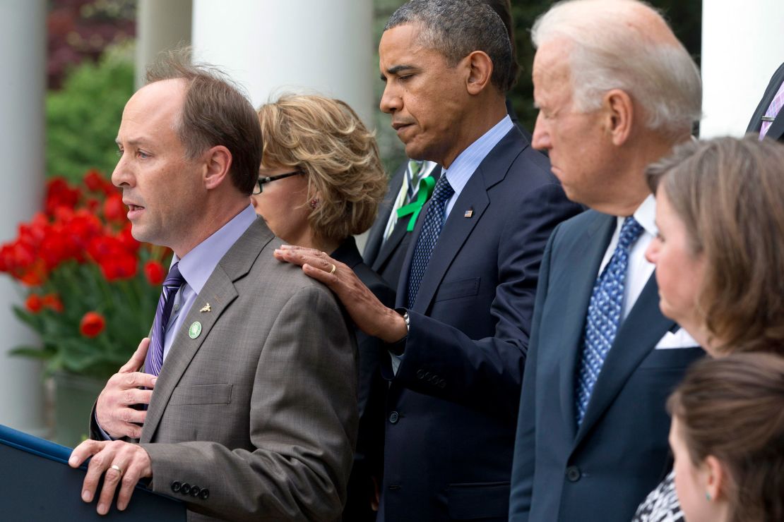 President Barack Obama places his hand on Mark Barden, left, during a 2013 news conference after the defeat of a bill to expand background checks.