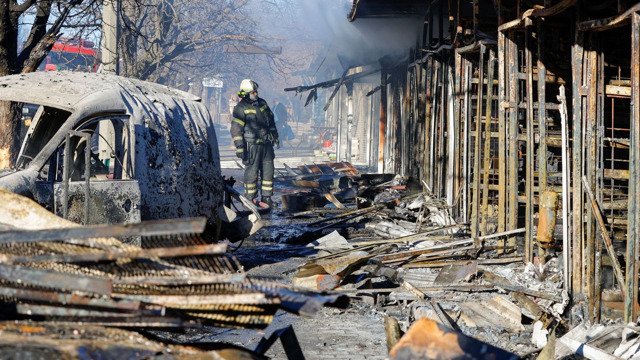 A firefighter stands in front of burned market stalls hit by shelling in Donetsk on December 6.