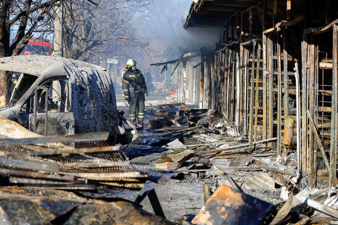 A firefighter stands in front of burned market stalls hit by shelling in Donetsk on December 6.