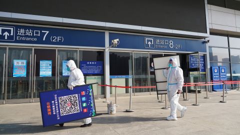 Workers remove QR health code signs at Xining Railway Station on December 8, 2022 in China's Qinghai province.