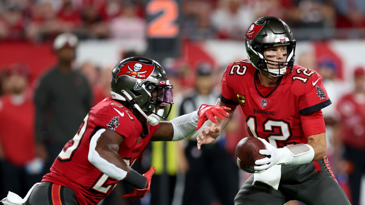 Tom Brady hands the ball off to Rachaad White against the New Orleans Saints during the first quarter in the game at Raymond James Stadium on December 05.
