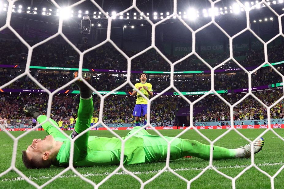 Croatian goalkeeper Dominik Livaković celebrates after Marquinhos hit the post on the last kick of the penalty shootout. It was Croatia's second straight shootout win in this World Cup.