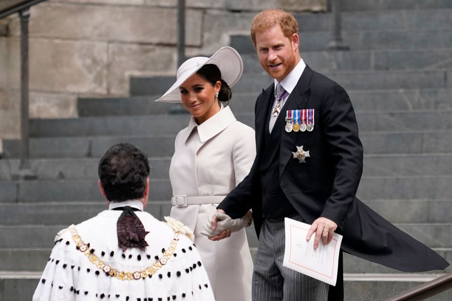 Harry and Meghan depart St Paul's Cathedral in London after attending a service honoring Queen Elizabeth II in June 2022. They flew in from the United States to attend the Queen's jubilee celebrations, and they were warmly welcomed by a crowd outside the service.