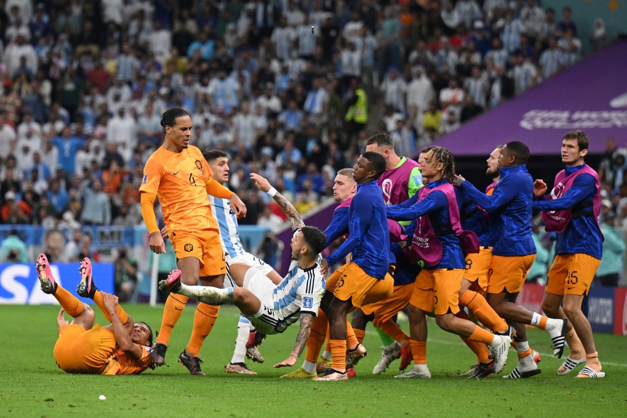 Van Dijk knocks over Paredes as Dutch players run onto the field in the second half. The skirmish started after a hard Paredes foul on Nathan Aké. Paredes then smashed the ball into the Dutch bench.