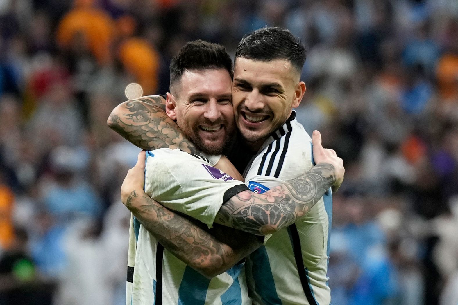 Argentina's Lionel Messi, left, and Leandro Paredes celebrate their berth in the semifinals.