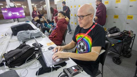 Wahl wearing a rainbow-colored t-shirt while working at Qatar 2022.