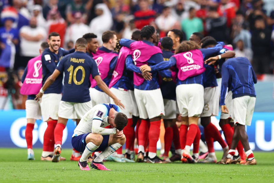 England's Mason Mount appears dejected as French players celebrate their 2-1 quarterfinal win at the World Cup on December 10.