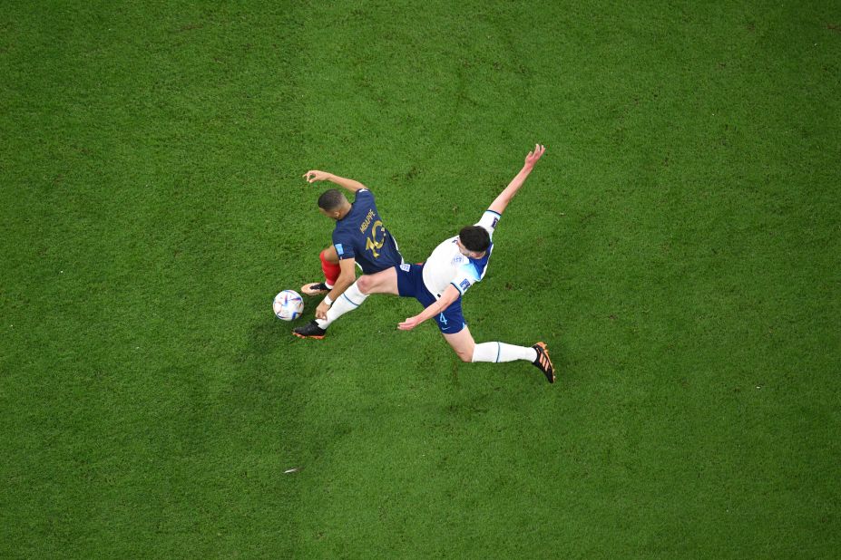 French star Kylian Mbappé is tackled by England's Declan Rice.