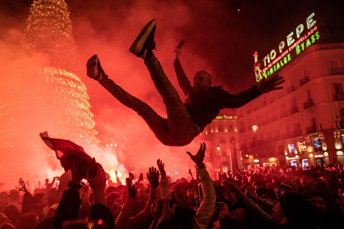 A man flies over the crowd as fans of the Moroccan soccer team celebrate in Madrid.