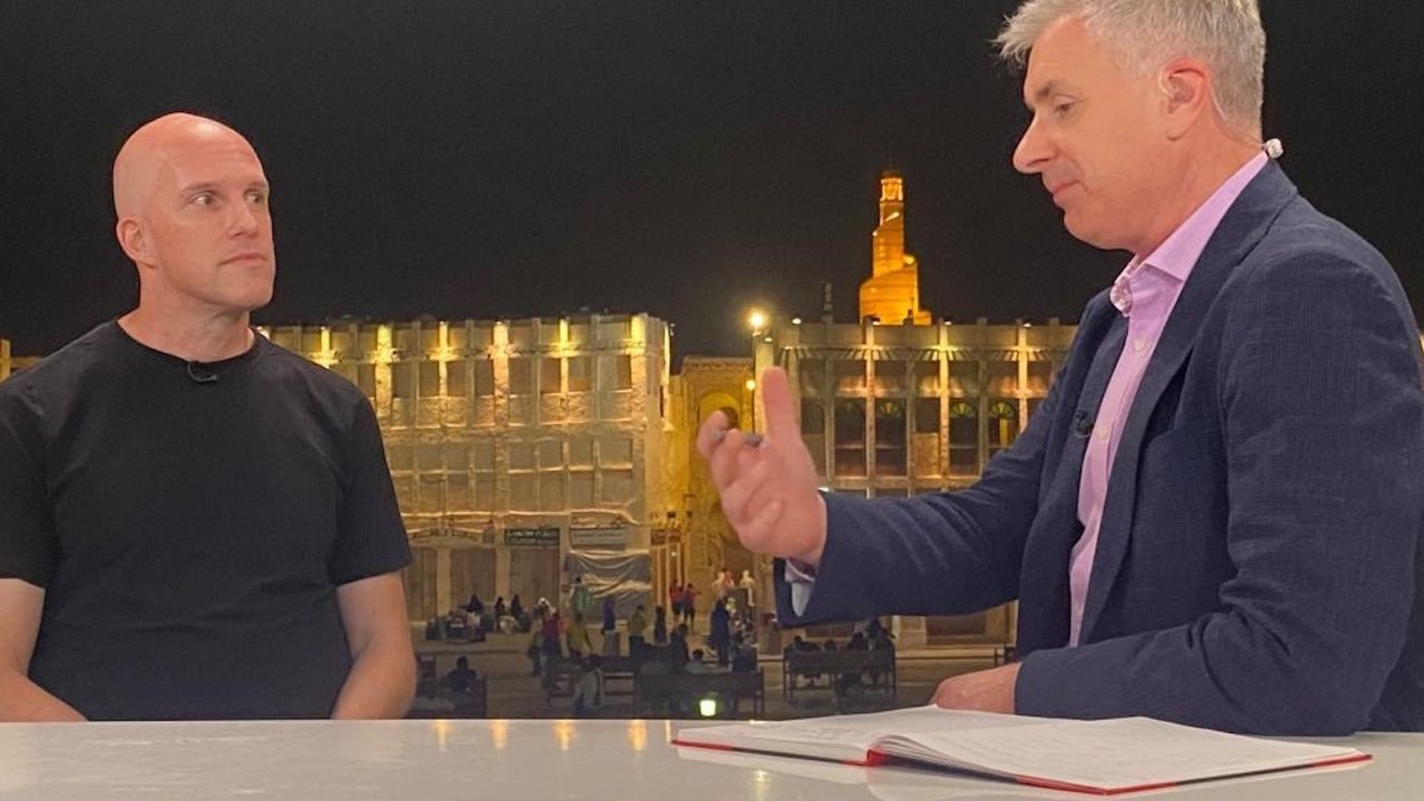 Grant Wahl (left) being interviewed by CNN's Don Riddel in Qatar. 
