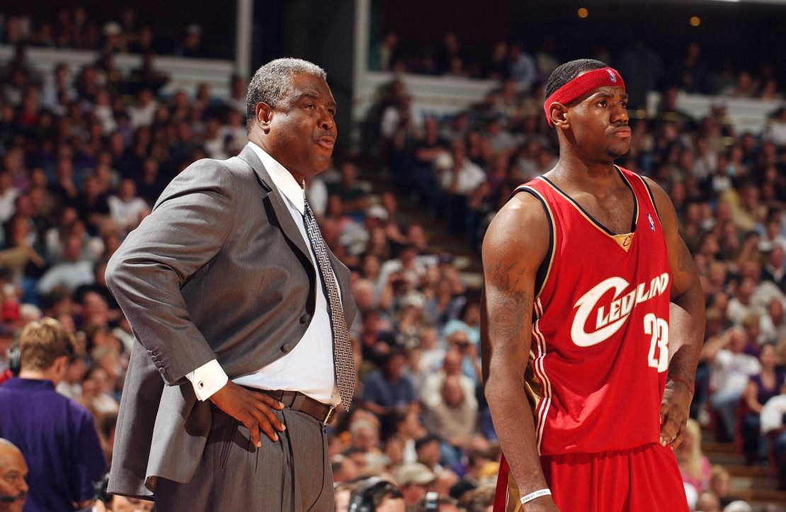 (From left to right) Head coach Paul Silas and LeBron James of the Cleveland Cavaliers look on during the game against the Sacramento Kings at Arco Arena on October 29, 2003, in Sacramento, California. 